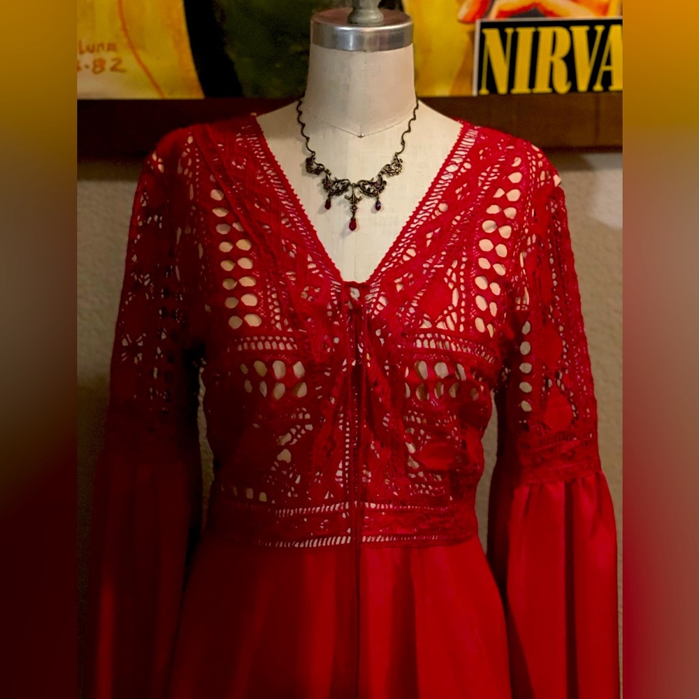 Brand new red dress, embroidered top and flows out just above the knees.